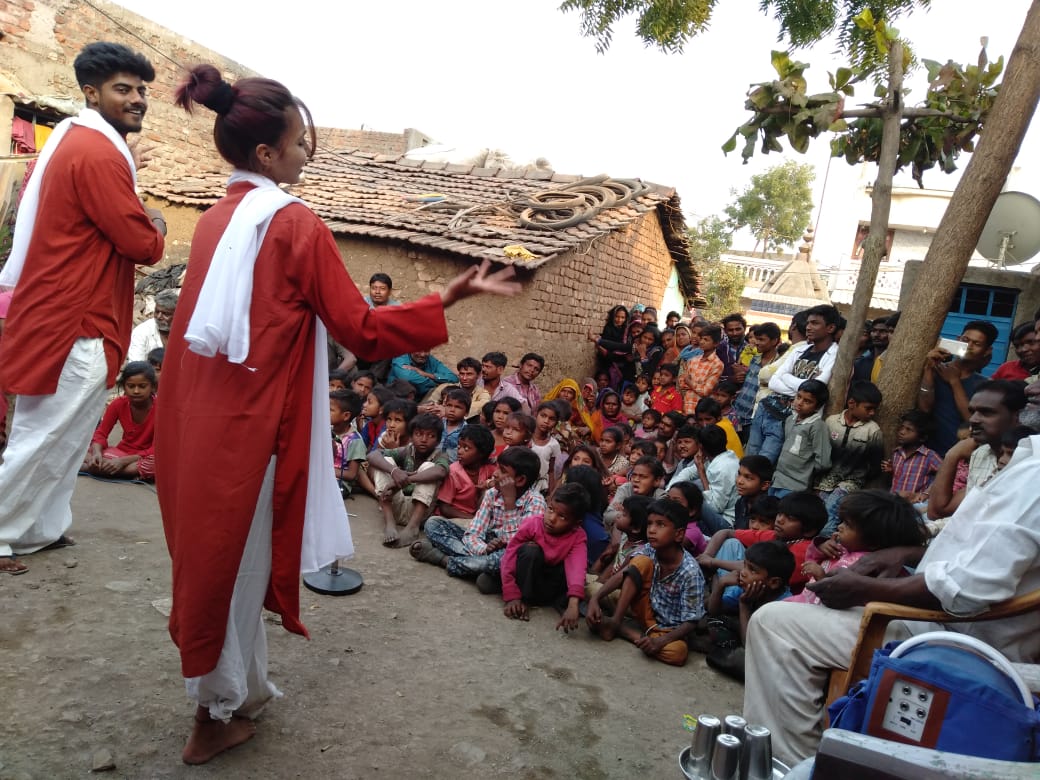 Street performance with audience gathered around Bhavai artists